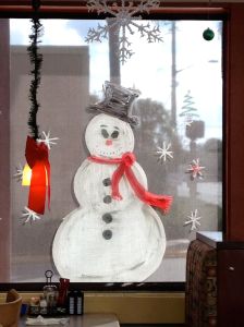 A painted snowman, seen from inside Christo's Cafe on Edgewater Drive in Orlando's College Park.