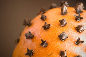 My 1940s directions call for covering fruit with cloves, but others suggest making patterns with the cloves.